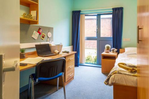 a bedroom with a desk with a laptop and a bed at Carrock Hall, University of Cumbria Carlisle in Carlisle