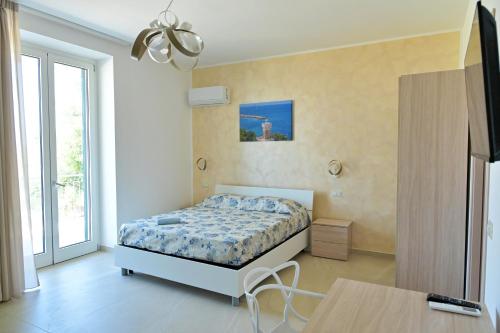 a bedroom with a bed and a table at Villa Melina Bed & Breakfast in Agropoli