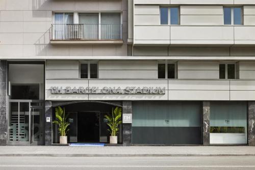 a building with a sign that reads the academy on station at NH Barcelona Stadium in Barcelona