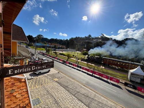 a train is stopped at a train station at Apartamento no Capivari - Centro Turístico in Campos do Jordão