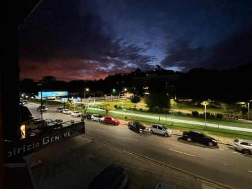 a view of a street with cars parked on the road at Apartamento no Capivari - Centro Turístico in Campos do Jordão