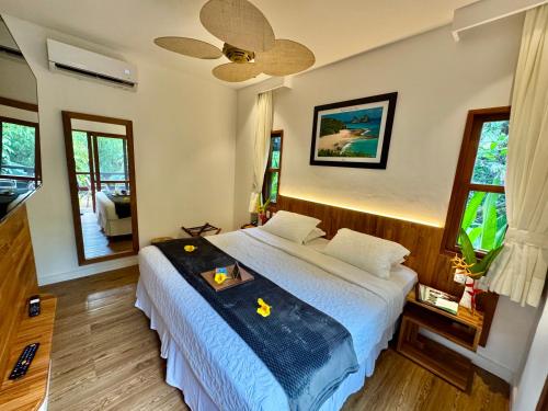 a bedroom with a bed with a tray on it at Pousada do Vale in Fernando de Noronha