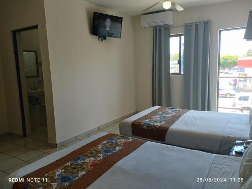 Ένα ή περισσότερα κρεβάτια σε δωμάτιο στο Hotel Hacienda Nainari