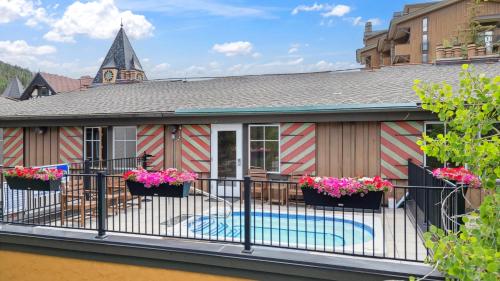 a house with a balcony with a swimming pool at Lift House Lodge, Lionshead Village View, Studio Condo in Vail