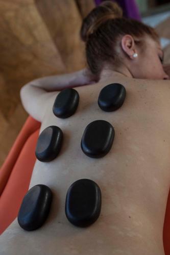 a woman laying on her back with black rocks at Hotel Balneario de Graena in Graena