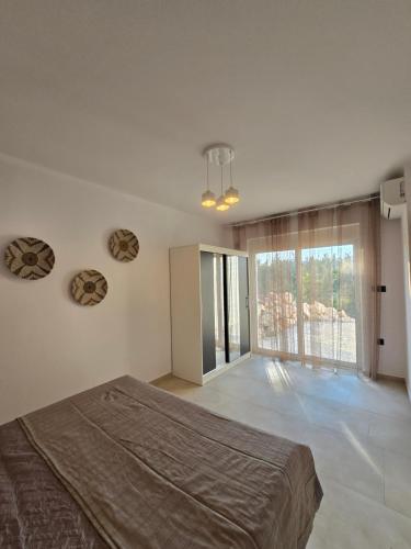 a bedroom with a bed and a large window at Villa & Apartament Armonia 3 Gaia Flora GRECJA KRETA in Vamos