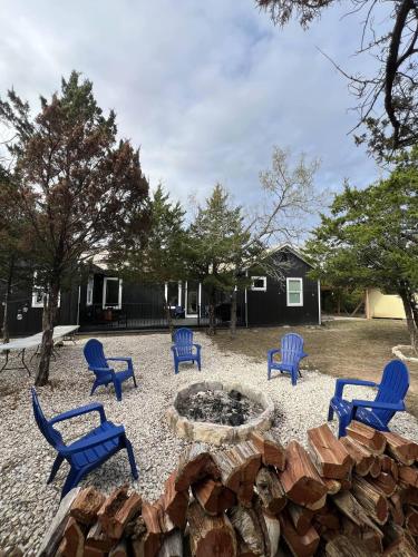 a group of blue chairs around a fire pit at Private Modern Urban Retreat in Cedar Creek