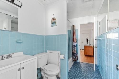 a blue and white bathroom with a toilet and a sink at 2 Bed1 Bath on the Boardwalk by the Inlet in Ocean City