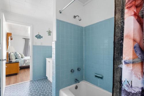 a bathroom with blue tiles on the walls and a tub at 2 Bed1 Bath on the Boardwalk by the Inlet in Ocean City