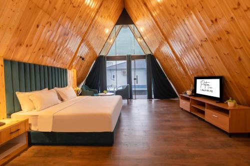a bedroom with a bed and a television in it at Patio Farms by Saltstayz in Farrukhnagar