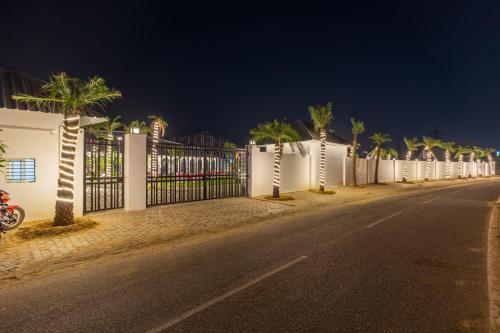 a fence on the side of a street at night at Patio Farms by Saltstayz in Farrukhnagar