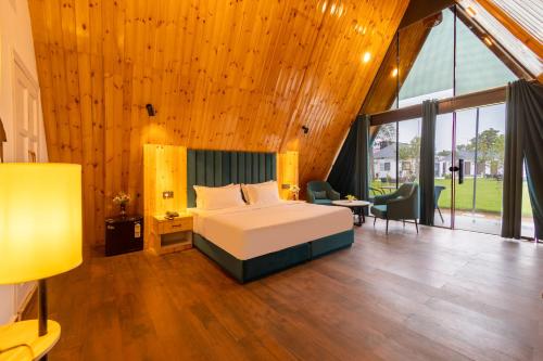 a bedroom with a bed and a large wooden ceiling at Patio Farms by Saltstayz in Farrukhnagar