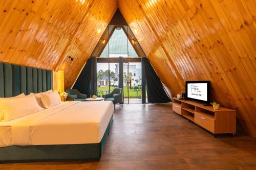 a bedroom with a bed with a wooden ceiling at Patio Farms by Saltstayz in Farrukhnagar
