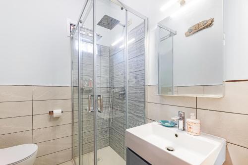 a bathroom with a shower and a sink and a toilet at Casa Lola - Goelba in Capoliveri
