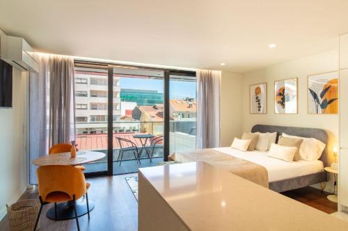 a hotel room with a bed and a balcony at HILCROWN 39 Studios by LovelyStay in Vila Nova de Gaia