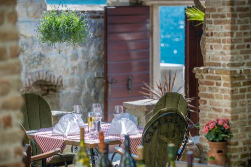 a table with wine glasses and napkins on a patio at Apartments Babilon in Kotor