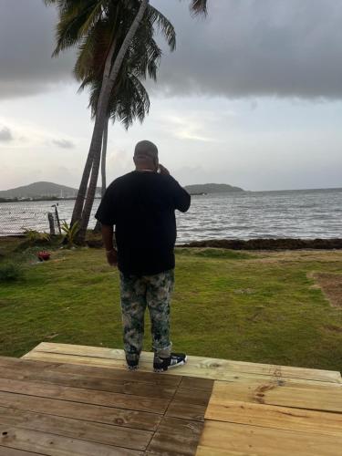 a man is walking on a skateboard near the ocean at Monaco in Fajardo