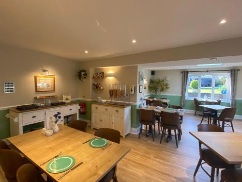 a kitchen and dining room with a table and chairs at Gordons in Cheddar