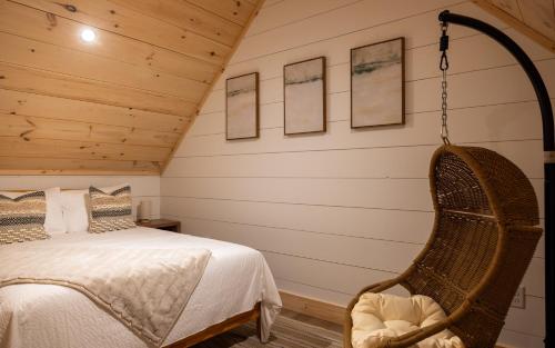 a bedroom with a bed and a swing at Arrow Head Cabin in Killington