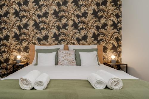 a bedroom with a large bed with towels on it at Old Town Luxe Retreat - King Bed - Steps to Main Square in Kraków