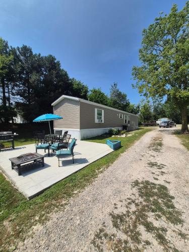 a patio with a picnic table and umbrella and a building at Lake Point Motel in Marblehead