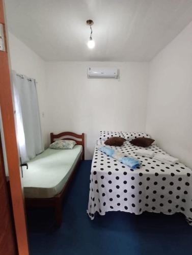 a bedroom with a black and white polka dot bed at Casa Beira Mar - Boipeba in Ilha de Boipeba
