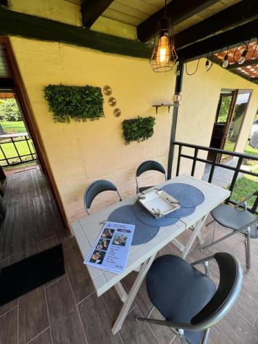 a table with chairs and a suitcase on top of it at Hospedaje Curiquindi - Mindo Eco Lodge in Mindo