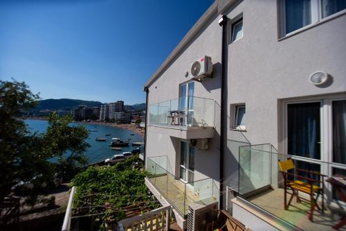 a balcony of a building with a view of a river at ACIKA apartments in Rafailovici