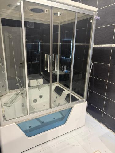 a bathroom with a shower with a glass wall at استديو زارا in Taif