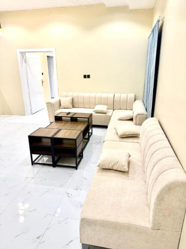 a living room with a couch and a coffee table at استديو زارا in Taif