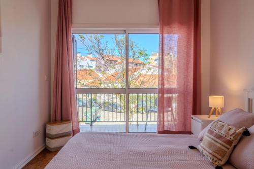 En eller flere senge i et værelse på Caparica Beach House Holiday Home