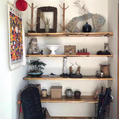 a shelf with various items on it in a room at Dan’s Sea Guest House Hangzhou in Hangzhou