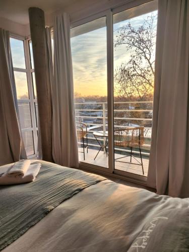 a bedroom with a bed and a view of a balcony at Studio apartment mitre in Saladillo