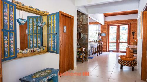 a hallway of a house with colorful glass windows at Sitio em Domingos Martins com Piscina e Vista in Domingos Martins
