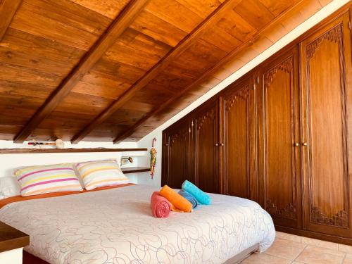 a bedroom with a bed with colorful pillows on it at Cozy apartment & amazing views Albayzín in Granada