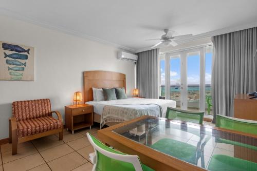 a hotel room with a bed and a table and chairs at Condado Lagoon by Otium in San Juan