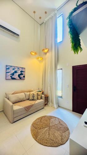 a living room with a couch and a table at Casa BoxHome em Santo Amaro-MA in Santo Amaro