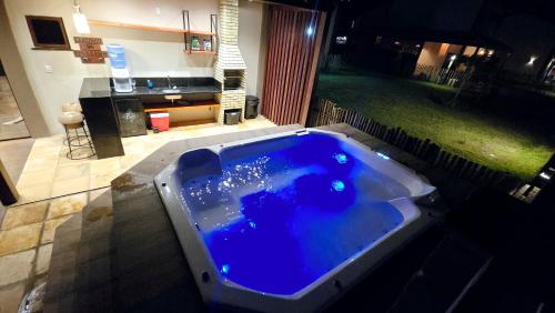 a large blue bath tub in a yard at night at Casa BoxHome em Santo Amaro-MA in Santo Amaro