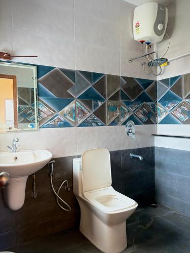 a bathroom with a toilet and a sink at 11 Haven Street Kodaikanal in Kodaikānāl