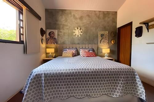 a bedroom with a large bed with a blue comforter at Casa LARVC no coração de Pirenópolis! in Pirenópolis