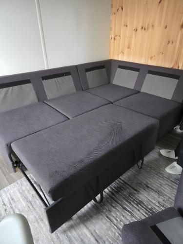 a bed with a black bed frame in a room at Tiny House Lohse in Wemding