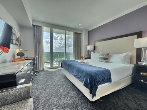a bedroom with a large bed and a large window at Private Oasis at Arya in Miami