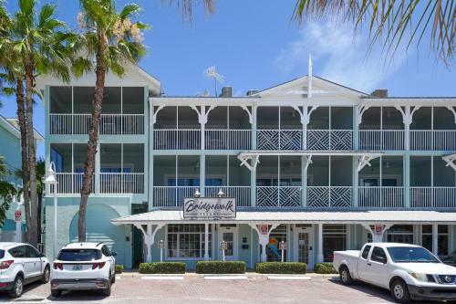 a large building with cars parked in front of it at Bridgewalk, a Landmark Resort in Bradenton Beach