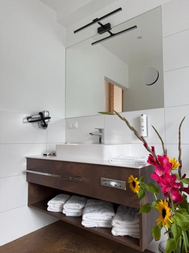 a bathroom with a sink and a mirror at Seehotel Lilly in Strobl