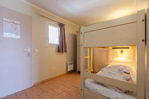 ein kleines Schlafzimmer mit einem Etagenbett darin in der Unterkunft Résidence les Calanques des Issambres - maeva Home - Studio 4 Personnes - Sélection MAE-8566 in Les Issambres