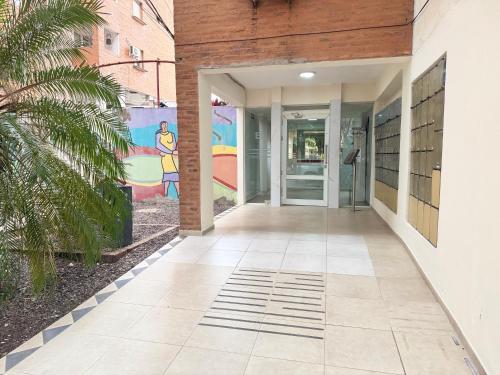 a hallway of a building with a mural on the wall at Temporario en Resistencia con cochera in Resistencia