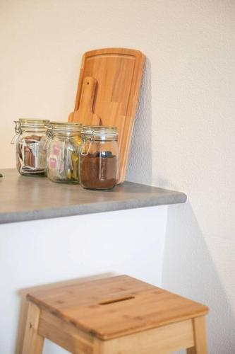 a table with a wooden chair and jars on it at Brisas de Güimar in Santa Cruz de Tenerife