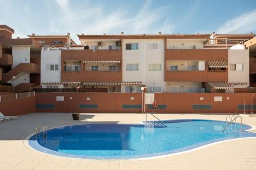 a swimming pool in front of a building at Brisas de Güimar in Santa Cruz de Tenerife