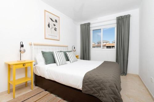 a bedroom with a large bed and a window at Brisas de Güimar in Santa Cruz de Tenerife