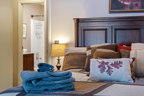 a bedroom with a bed with a wooden headboard at Luxury Condo Tucked in the Heart of Killington in Killington